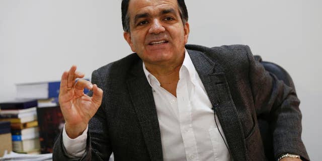 Oscar Ivan Zuluaga, presidential candidate for the Democratic Center speaks during an interview with Associated Press in Bogota, Colombia, Tuesday, June 3, 2014. Zualuaga will face President Juan Manuel Santos, who is seeking a second four-year term as candidate of the Social Party of National Unity, in a presidential runoff on June 15. (AP Photo/Fernando Vergara)