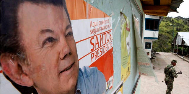 May 26: A soldier patrols under a poster of Juan Manuel Santos, the presidential candidate of the Social National Unity Party, in Nazareth, south of Bogota, The government has tightened the security ahead of May 30 presidential election.