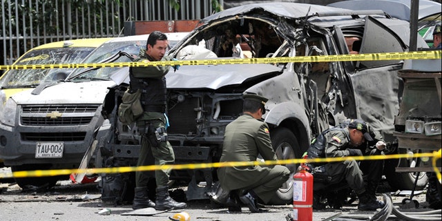 May 15, 2012: Police inspect the scene after a bomb exploded in Bogota, Colombia.