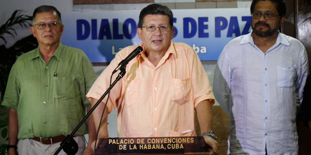 Pablo Catatumbo, chief of the western bloc of the Revolutionary Armed Forces of Colombia, or FARC, center, speaks to journalists accompanied by Ricardo Tellez, left, and Ivan Marquez, chief FARC negotiator during peace talks with Colombia's government in Havana, Cuba, Friday, Aug. 23, 2013. Colombia's largest guerrilla army temporarily walked away from peace talks with the government Friday over President Juan Manuel Santos' refusal to agree to modify the constitution if a peace pact is struck. (AP Photo/Ismael Francisco, Cubadebate)
