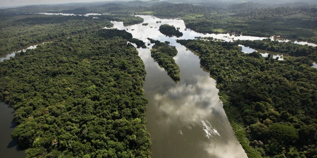 NEAR ALTAMIRA, BRAZIL - JUNE 15: The Xingu River flows near the area where the Belo Monte dam complex is under construction in the Amazon basin on June 15, 2012 near Altamira, Brazil. Belo Monte will be the worldâs third-largest hydroelectric project and will displace up to 20,000 people while diverting the Xingu River and flooding as much as 230 square miles of rainforest. The controversial project is one of around 60 hydroelectric projects Brazil has planned in the Amazon to generate electricity for its rapidly expanding economy. While environmentalists and indigenous groups oppose the dam, many Brazilians support the project. The Brazilian Amazon, home to 60 percent of the worldâs largest forest and 20 percent of the Earthâs oxygen, remains threatened by the rapid development of the country. The area is currently populated by over 20 million people and is challenged by deforestation, agriculture, mining, a governmental dam building spree, illegal land speculation including the occupation of forest reserves and indigenous land and other issues. Over 100 heads of state and tens of thousands of participants and protesters will descend on Rio de Janeiro, Brazil, later this month for the Rio+20 United Nations Conference on Sustainable Development or âEarth Summitâ. Host Brazil is caught up in its own dilemma between accelerated growth and environmental preservation.   (Photo by Mario Tama/Getty Images)