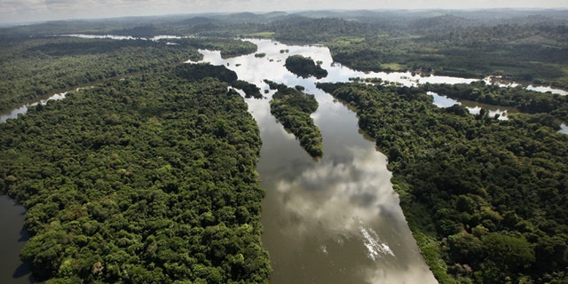 NEAR ALTAMIRA, BRAZIL - JUNE 15: The Xingu River flows near the area where the Belo Monte dam complex is under construction in the Amazon basin on June 15, 2012 near Altamira, Brazil. Belo Monte will be the worldâs third-largest hydroelectric project and will displace up to 20,000 people while diverting the Xingu River and flooding as much as 230 square miles of rainforest. The controversial project is one of around 60 hydroelectric projects Brazil has planned in the Amazon to generate electricity for its rapidly expanding economy. While environmentalists and indigenous groups oppose the dam, many Brazilians support the project. The Brazilian Amazon, home to 60 percent of the worldâs largest forest and 20 percent of the Earthâs oxygen, remains threatened by the rapid development of the country. The area is currently populated by over 20 million people and is challenged by deforestation, agriculture, mining, a governmental dam building spree, illegal land speculation including the occupation of forest reserves and indigenous land and other issues. Over 100 heads of state and tens of thousands of participants and protesters will descend on Rio de Janeiro, Brazil, later this month for the Rio+20 United Nations Conference on Sustainable Development or âEarth Summitâ. Host Brazil is caught up in its own dilemma between accelerated growth and environmental preservation. (Photo by Mario Tama/Getty Images)