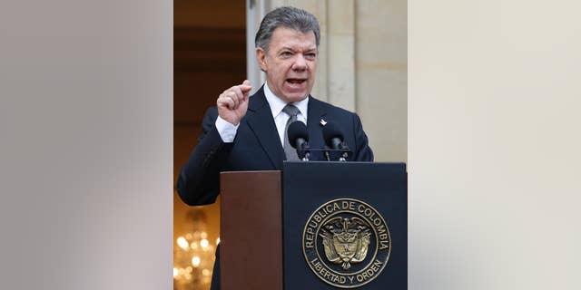 Colombia's President Juan Manuel Santos speaks to the media after a welcoming ceremony for South Korea's President Park Geun-hye at the presidential palace in Bogota, Colombia, Friday, April 17, 2015. In a sharply worded rebuke, Santos said Colombians' patience is wearing thin after guerrillas this week attacked an army platoon sleeping in the field and killed 11 soldiers.  (AP Photo/Fernando Vergara)