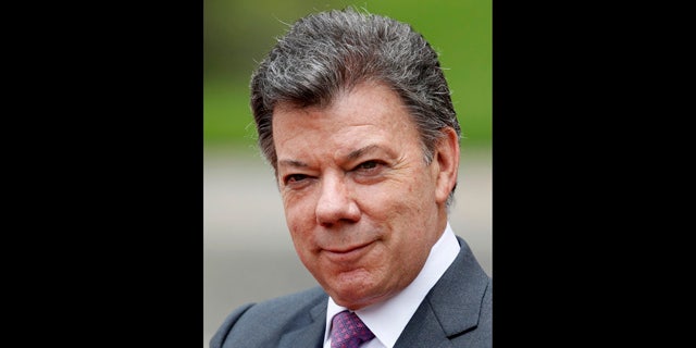 April 19, 2012: Colombia's President Juan Manuel Santos waits for the arrival of Spain's Prime Minister Mariano Rajoy at the presidential palace in Bogota, Colombia. Santos said on Monday, Oct. 1, 2012, he suffers from prostate cancer and he will undergo surgery next Wednesday at a clinic in Bogota.