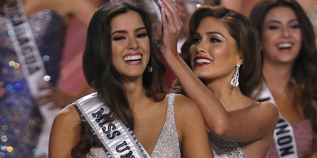 In this Jan. 25, 2015, file photo, reigning Miss Universe Gabriela Isler, right, crowns the new Miss Universe, Paulina Vega of Colombia, left, during the Miss Universe pageant in Miami, Sunday.