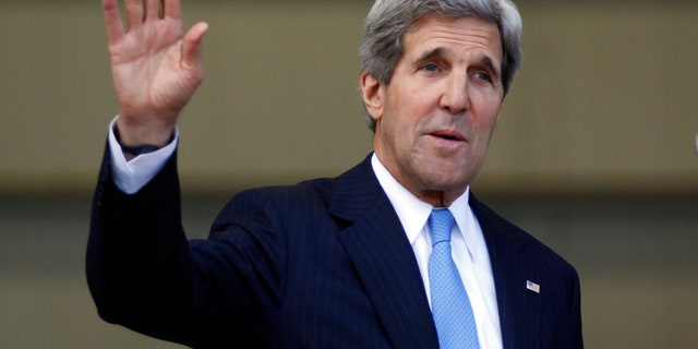 U.S. Secretary of State John Kerry waves journalist after a press conference at the headquarters of the Colombian National Police Counter-Narcotics in Bogota, Colombia, Monday, Aug. 12, 2013. Kerry is on a one-day official visit to Colombia. (AP Photo/Fernando Vergara)