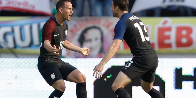 United States' Luis Gil, left, celebrates with teammate Matt Polster after scoring his side's first goal against Colombia during a U-23 first leg soccer match qualifier for the 2016 Rio Olympics at the Roberto Melendez Stadium in Barranquilla, Colombia, Friday, March 25, 2016. (AP Photo/Fernando Vergara)