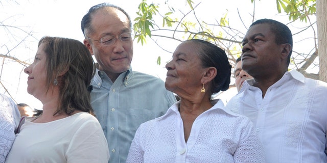 World Bank President Dr. Jim Yong Kim looks at Norma Quiroz, widow of slain community activist Aljemiro Quiroz, in Guacoche, Colombia, Thursday, Jan. 14, 2016.