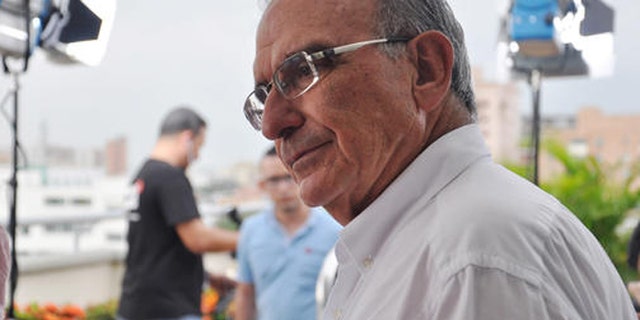 In this Sept. 14, 2016 photo, the chief peace negotiator for the Colombian government, Humberto De la Calle, talks to an aide in Barranquilla, Colombia. After securing in Cuba a historic peace deal with the FARC rebels, some are talking about him as a possible successor to Colombia's President Juan Manuel Santos in 2018. Santos will sign the peace accord next week and Colombians will be asked in an Oct. 2 referendum to ratify or reject the deal. (AP Photo/Joshua Goodman)