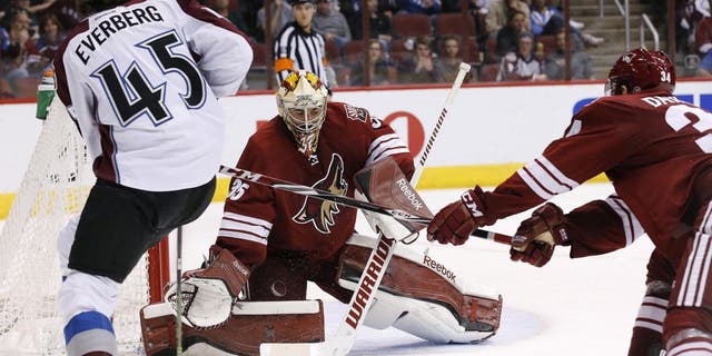 Colorado Avalanche's Dennis Everberg (45), of Sweden, passes the puck past Arizona Coyotes' Louis Domingue (35) as Coyotes' Klas Dahlbeck (34), of Sweden, during the third period of an NHL hockey game Thursday, March 19, 2015, in Glendale, Ariz. The Avalanche defeated the Coyotes 5-2. (AP Photo/Ross D. Franklin)