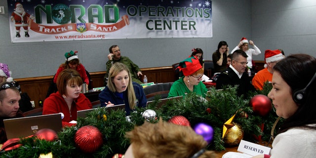 Dec. 24, 2012: Volunteers take phone calls from children asking where Santa is and when he will deliver presents to their house, during the annual NORAD Tracks Santa Operation, at the North American Aerospace Defense Command, or NORAD, at Peterson Air Force Base, in Colorado Springs, Colo.