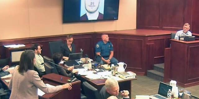 Defense attorney Tamara Brady, left, questions Robert Holmes, top right, the father of James Holmes, background left, during the sentencing phase of the Colorado theater shooting trial.