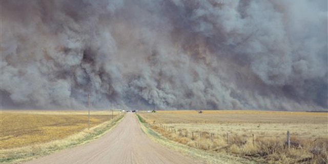 March 18, 2012: A wildfire sends up a huge wall of smoke, forcing authorities to temporarily close a section of U.S. Highway 34 east of Yuma County, Colo., when the fire filled the skies with so much smoke that firefighters couldn't see the flames.