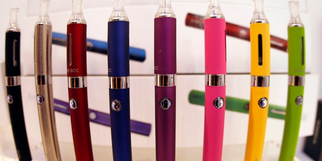 A window display with different color models of electronic cigarettes.