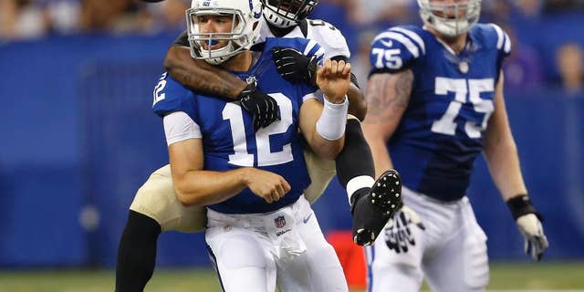 FILE - In this Aug. 23, 2014, file photo, Indianapolis Colts quarterback Andrew Luck (12) loses the ball as he's sacked by New Orleans Saints outside linebacker Junior Galette during the first half of an NFL preseason football game in Indianapolis. The Colts aren't be sure what the offensive line will look like Sunday, Sept. 7, against Denver. (AP Photo/Sam Riche)
