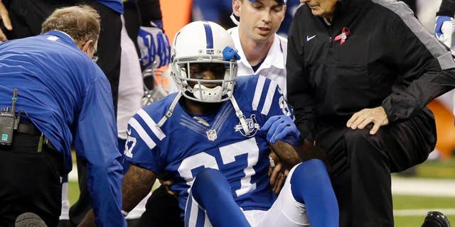FILE - In this Oct. 20, 2013, file photo, Indianapolis Colts wide receiver Reggie Wayne (87) talks to trainers after he injured his knee during the second half of an NFL football game against the Denver Broncos in Indianapolis. The last time Wayne played in a regular-season game, he was limping off the field against Denver. On Sunday night, he'll return against those same Broncos and his old friend Peyton Manning. For Wayne, it's the culmination of a 9 1/2-month recovery from a torn ACL in his right knee. (AP Photo/Michael Conroy, File)