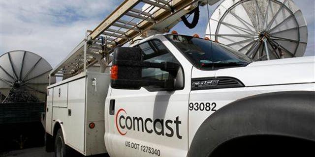 In this Thursday, April 25, 2013, photo, a Comcast truck is parked in Berlin, Vt.
