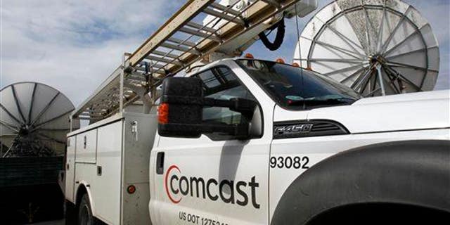 In this Thursday, April 25, 2013, photo, a Comcast truck is parked in Berlin, Vt.