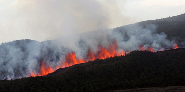 Lava flows down the slope of Nyamulagira volcano 25 miles northwest of Goma, North Kivu, Congo.