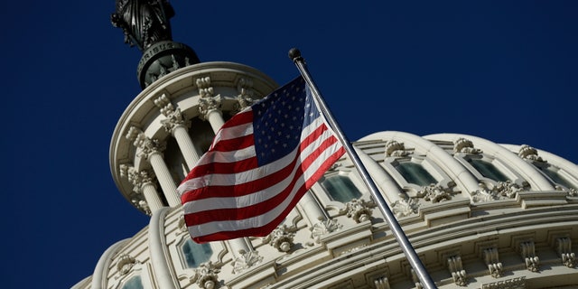 WASHINGTON, DC - SEPTEMBER 29: An American flag waves outside the United States Capitol building as Congress remains gridlocked over legislation to continue funding the federal government September 29, 2013 in Washington, DC. The House of Representatives passed a continuing resolution with language to defund U.S. President Barack Obama's national health care plan yesterday, but Senate Majority Leader Harry Reid has indicated the U.S. Senate will not consider the legislation as passed by the House. (Photo by Win McNamee/Getty Images)
