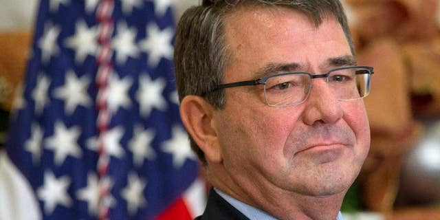FILE - In this Dec. 5, 2014 file photo, Ashton Carter listens as President Barack Obama announces Carter as his nominee for defense secretary, in the Roosevelt Room of the White House in Washington. The Senate Armed Services Committee is holding a confirmation hearing next week to consider Ashton Carter to be the next secretary of defense. President Barack Obama nominated Carter to succeed Chuck Hagel, who resigned under pressure from Obama.(AP Photo/Jacquelyn Martin, File)