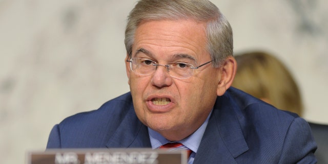 FILE - In this Sept. 4, 2013, file photo, Sen. Robert Menendez, D-N.J. speaks at Capitol Hill in Washington. Key Democratic and Republican senators are crafting legislation to reinstate the full force of Iran sanctions and impose new ones if Tehran doesnât make good on its pledge to roll back its nuclear program, brushing aside the Obama administrationâs fears about upending its diplomatic momentum. Menendez and Sen. Mark Kirk, R-Ill., hope to have the bill ready for other lawmakers to consider when the Senate returns Dec. 9 from its two-week recess, according to legislative aides. (AP Photo/Susan Walsh)