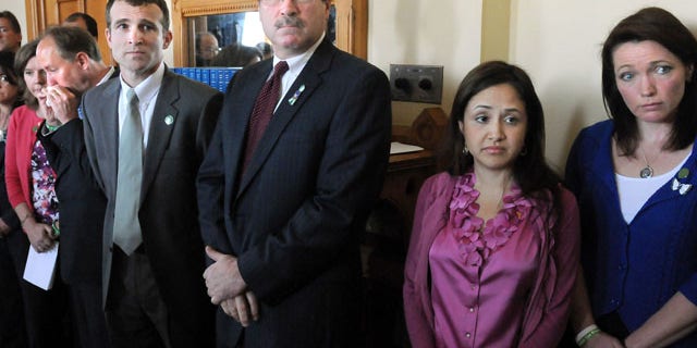 April 1, 2013: Relatives and supporters of Sandy Hook Elementary School shooting victims stand during a presentation at the Capital in Hartford, Conn.