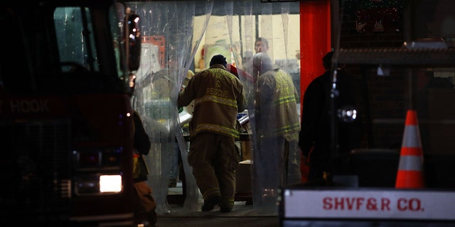 NEWTOWN, CT - DECEMBER 14: A firefighter from the Sandy Hook Fire and Rescue walks into the firehouse near the Sandy Hook School on December 14, 2012 in Newtown, Connecticut. Twenty-seven are dead, including 20 children, after a gunman identified as Adam Lanza in news reports, opened fire in the school. Lanza also reportedly died at the scene. (Photo by Spencer Platt/Getty Images)