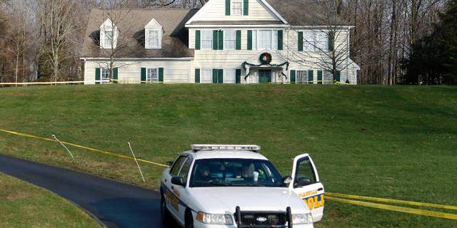 FILE - In this Dec. 18, 2012, file photo, a police cruiser sits in the driveway of the home of Nancy Lanza in Newtown, Conn., the Colonial-style house where she had lived with her son Adam Lanza. Newtown Legislative Council Chair Mary Ann Jacob said Tuesday, March 24, 2015, that the building was torn down on Monday. Nancy Lanza was killed there by her son before he forced his way into Sandy Hook Elementary School on Dec. 14, 2012, in Newtown, where he killed 20 first-graders and six educators. (AP Photo/Jason DeCrow, File)