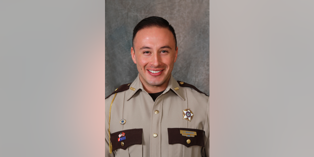 Scott County Deputy Jaime Morales is seen in an undated photo provided by the Scott County Sheriff's Office. A Florida bank robbery suspect tracked down at an interstate rest stop in Kentucky late Tuesday was killed in a late-night exchange of gunfire that left Morales critically wounded, authorities said Wednesday, Sept. 12, 2018. The fugitive, Edward Reynolds, died at the rest stop, Kentucky State Police Trooper Bernis Napier said. (Scott County Sheriff's Office via AP)