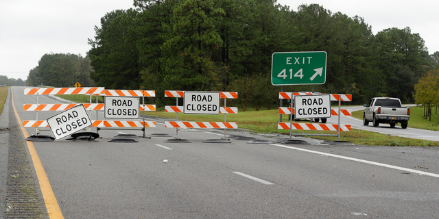 A truck exits Interstate 40 outside Wilmington, N.C., after damage from Hurricane Florence cut off the city Sunday, Sept. 16, 2018. (AP Photo/Chuck Burton)