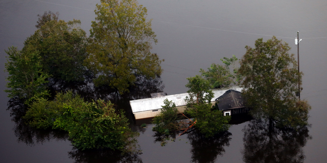 Floodwaters surround a trailer in the aftermath of Hurricane Florence in Pollocksville, N.C., Monday, Sept. 17, 2018. (AP Photo/Steve Helber)
