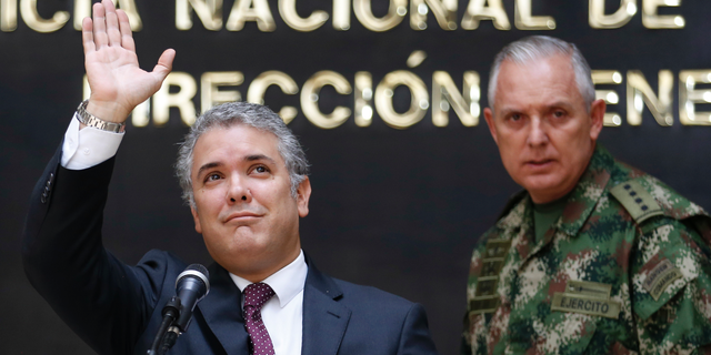 Colombia's President Ivan Duque waves during a press conference at police headquarters in Bogota, Sept. 19, 2018.
