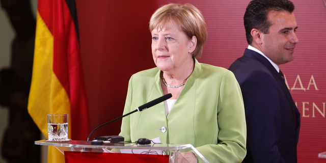 German Chancellor Angela Merkel and Macedonian Prime Minister Zoran Zaev, right, arrive for a news conference following their talks at the government building in Skopje, Macedonia, Saturday, Sept. 8, 2018. German chancellor Angela Merkel is a third western leader this week who has urged Macedonians to back massively the referendum on a deal with neighboring Greece aimed at ending a decades-old name dispute. (AP Photo/Boris Grdanoski)