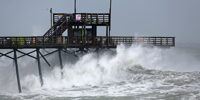 Waves from Hurricane Florence pound the Bogue Inlet Pier in Emerald Isle N.C., Thursday, Sept. 13, 2018. (AP Photo/Tom Copeland)
