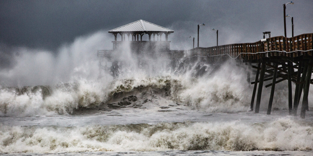 Waves slam the Oceana Pier & Pier House Restaurant in Atlantic Beach, N.C., Thursday, Sept. 13, 2018 as Hurricane Florence approaches the area. (Travis Long/The News & Observer via AP)