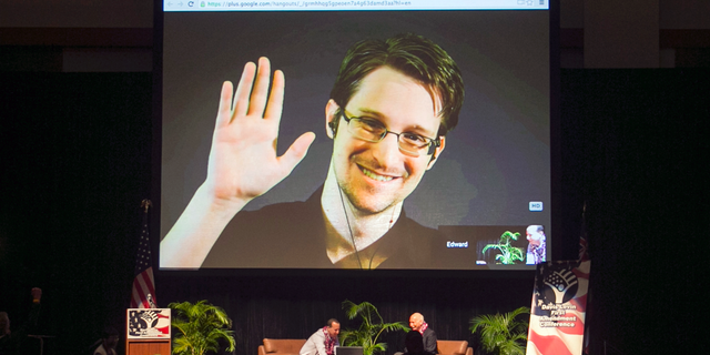 FILE - In this Feb. 14, 2015, file photo, Edward Snowden appears on a live video feed broadcast from Moscow at an event sponsored by ACLU Hawaii in Honolulu. Europe's human rights court is about to publish what could be a landmark ruling on the legality of mass surveillance. The case brought by civil liberties, human rights and journalism groups and campaigners challenges British surveillance and intelligence-sharing practices revealed by American whistleblower Edward Snowden. (AP Photo/Marco Garcia, File)