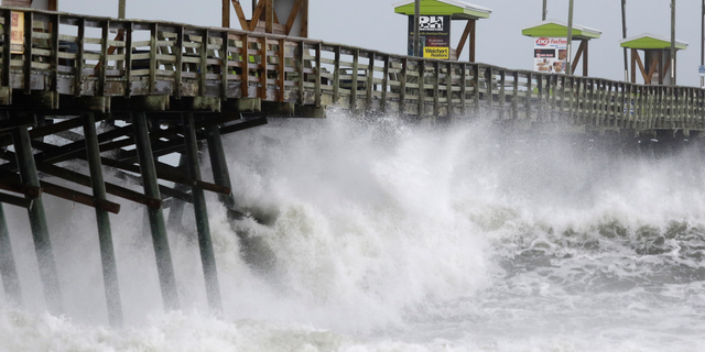 Waves from Hurricane Florence pound the Bogue Inlet Pier in Emerald Isle N.C., Thursday, Sept. 13, 2018. (AP Photo/Tom Copeland)