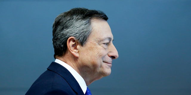 President of the European Central Bank Mario Draghi is on his way to a news conference in Frankfurt, Germany, Thursday, April 27, 2017.  (AP Photo/Michael Probst)