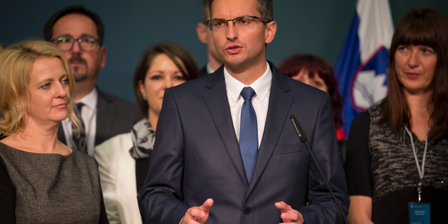 FILE - In this Sunday, Oct. 22, 2017 file photo, Slovenian presidential candidate Marjan Sarec talks to the media in Ljubljana, Slovenia. Once a satirist who impersonated prominent politicians, Marjan Sarec has taken the helm of a largely centrist government _ a rare phenomenon, at least recently, in Central Europe where populists have been on the march from Italy to Poland. (AP Photo/Darko Bandic, File)