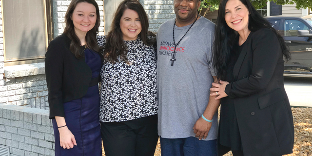 In this photo provided by the law firm Lassiter and Cassinelli, John Brown, second from right, poses with Midwest Innocence Project investigator Blair Johnson, MIP attorney Rachel Wester, and attorney Erin Cassinelli after Brown was released from prison on Wednesday, Sept. 19, 2018, in Little Rock, Ark. In August, a judge overturned Brown's 1992 conviction for the murder and robbery of an elderly woman. The state is appealing the judge's decision and Brown could still be retried. (Jene Louviere/Lassiter and Cassinelli via AP)