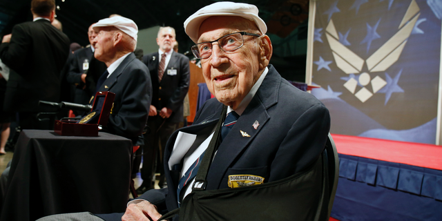 Two members of the Doolittle Tokyo Raiders, retired U.S. Air Force Lt. Col. Richard "Dick" Cole, seated front, and retired Staff Sgt. David Thatcher, seated left, pose for photos after the presentation of a Congressional Gold Medal. Cole, the unit's last surviving member, has died. (AP Photo/Gary Landers, File)