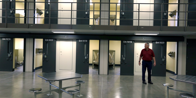 FILE - In this June 1, 2018, file photo, a man stands in a housing unit in the West section of the State Correctional Institution at Phoenix in Collegeville, Pa. Bill Cosby spent the first night of his three-to-10-year prison sentence for sexual assault alone in a single cell near the infirmary at the new state lock up outside Philadelphia. (AP Photo/Jacqueline Larma, File)