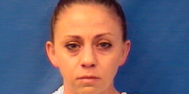 FILE - This file photo provided by the Kaufman County Sheriff's Office shows Amber Renee Guyger. Guyger, a Dallas police officer accused of fatally shooting her neighbor inside his own apartment has been dismissed, the police department announced Monday, Sept. 24, 2018. The Dallas Police Department fired Guyger weeks after she fatally shot 26-year-old Botham Jean inside his own apartment on Sept. 6. Court records show Guyger said she thought she had encountered a burglar inside her own home.(Kaufman County Sheriff's Office via AP, File)