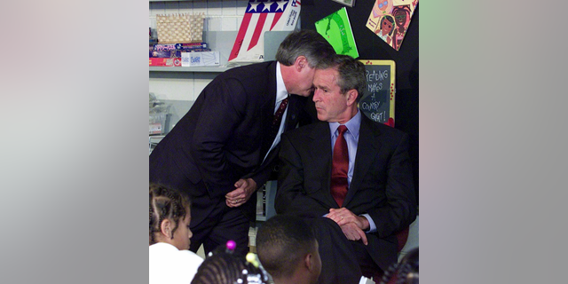 FILE - In this Tuesday, Sept. 11, 2001 file photo, Chief of Staff Andy Card whispers into the ear of President George W. Bush to give him word of the plane crashes into the World Trade Center, during a visit to the Emma E. Booker Elementary School in Sarasota, Fla. (AP Photo/Doug Mills, File)