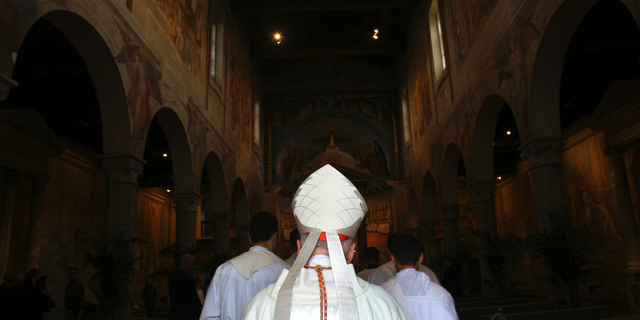 FILE - In this April 14, 2005 file photo, Washington Cardinal Theodore McCarrick enters the St. Nereus and Achilleus Church in Rome. In July 2018, Pope Francis removed the U.S. church leader as a cardinal after church investigators said an allegation that he groped a teenage altar boy in the 1970s was credible. Subsequently, several former seminarians and priests reported that they too had been abused or harassed by McCarrick as adults. (AP Photo/ Alessandra Tarantino)