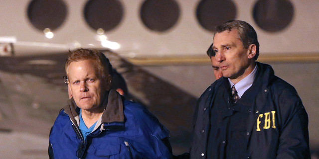FILE - In this Dec. 5, 2017, file photo, fugitive lawyer Eric Conn, left, is taken into custody by FBI agents on the tarmac at Blue Grass Airport in Lexington, Ky. Conn, an eastern Kentucky disability attorney who masterminded the largest Social Security fraud in history, has been sentenced to an additional 15 years in prison for fleeing the country in an effort to avoid prosecution on Friday, Sept. 7, 2018. (AP Photo/Matt Goins, File)