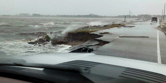 In this photo provided by Jordan Guthrie, wind and water from Hurricane Florence damages the highway leading off Harkers Island, N.C. on Friday, Sept. 14, 2018.  (Jordan Guthrie via AP)