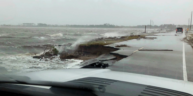 In this photo provided by Jordan Guthrie, wind and water from Hurricane Florence damages the highway leading off Harkers Island, N.C. on Friday, Sept. 14, 2018. (Jordan Guthrie via AP)