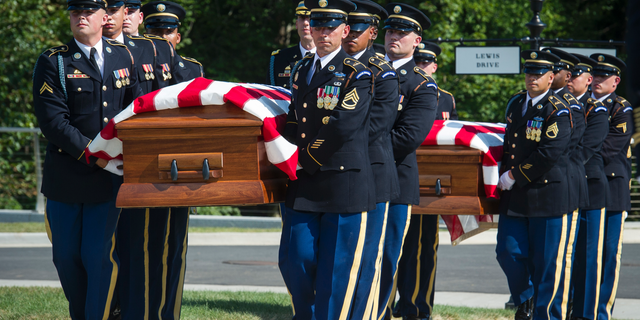 The 3rd Infantry Regiment, also known as the Old Guard, casket teams carry the remains of two unknown Civil War Union soldiers to their grave at Arlington National Cemetery in Arlington, Va., Thursday, Sept. 6, 2018. The soldiers were discovered at Manassas National Battlefield and will be buried in Section 81. Arlington National Cemetery opened the new section of gravesites with the burial. (AP Photo/Cliff Owen)